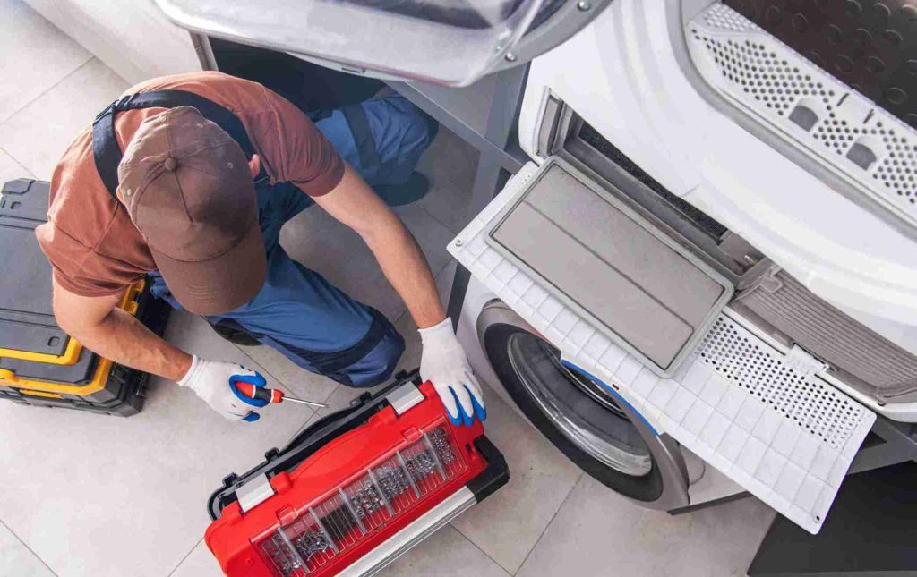 Washing Machine Fixing by Caucasian Professional Technician stock photo